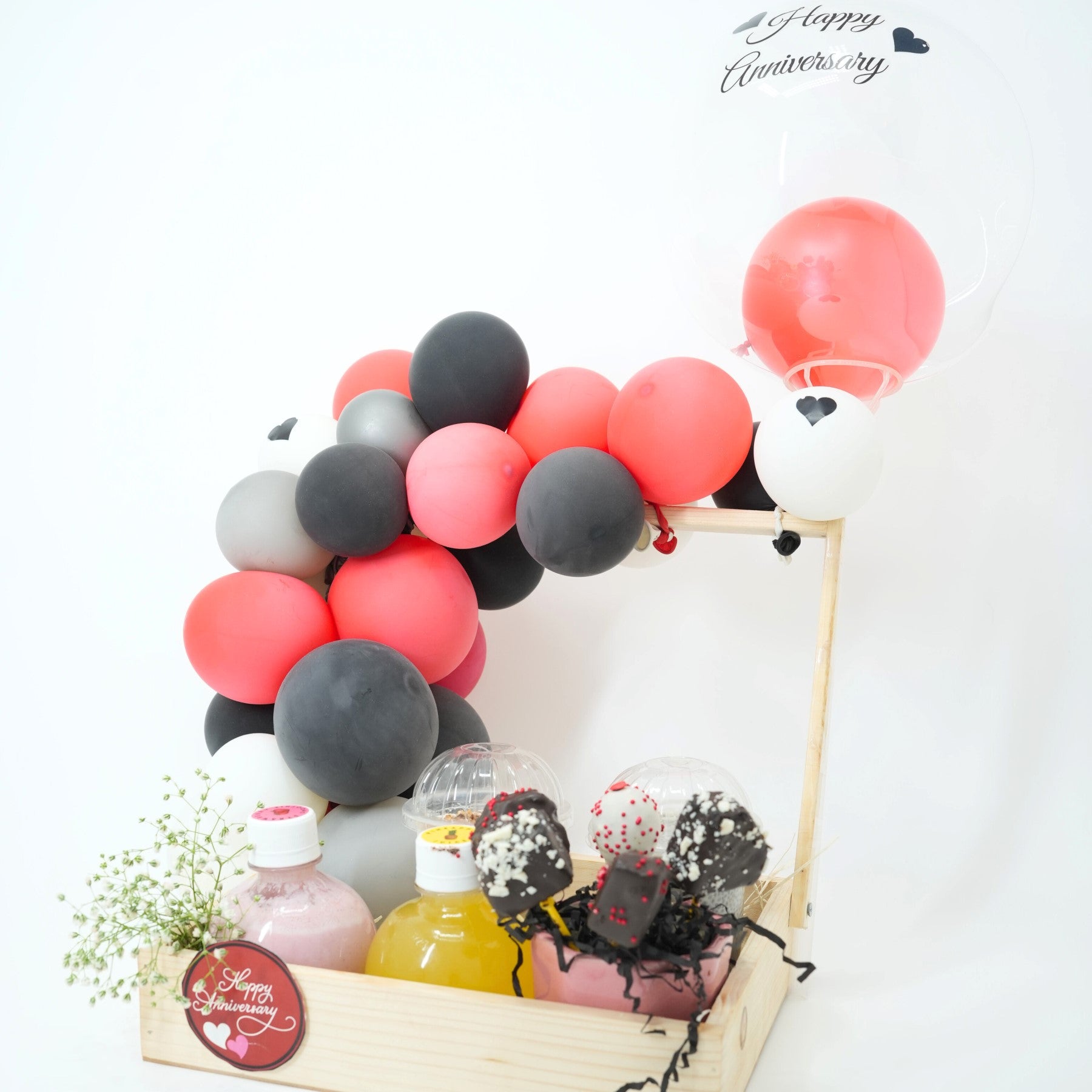 Decorative balloon arch with bottles and flowers on a white background